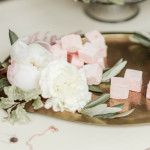a brass art nouveau tray with pink marshmallows and white flowers